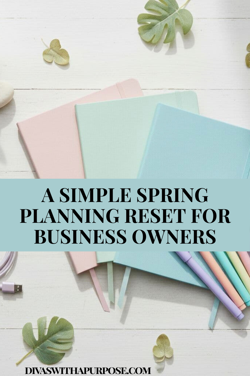 Pastel notebooks and colorful pens arranged on a white desk with spring leaves and text about a simple spring planning reset for business owners