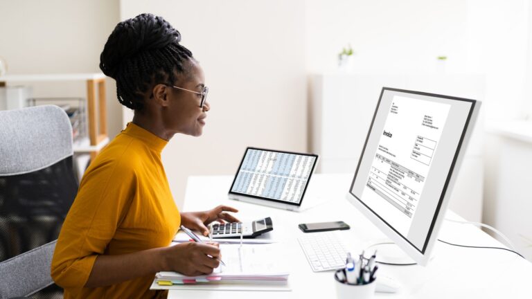 Accountant workign at a desk looking at computer screen