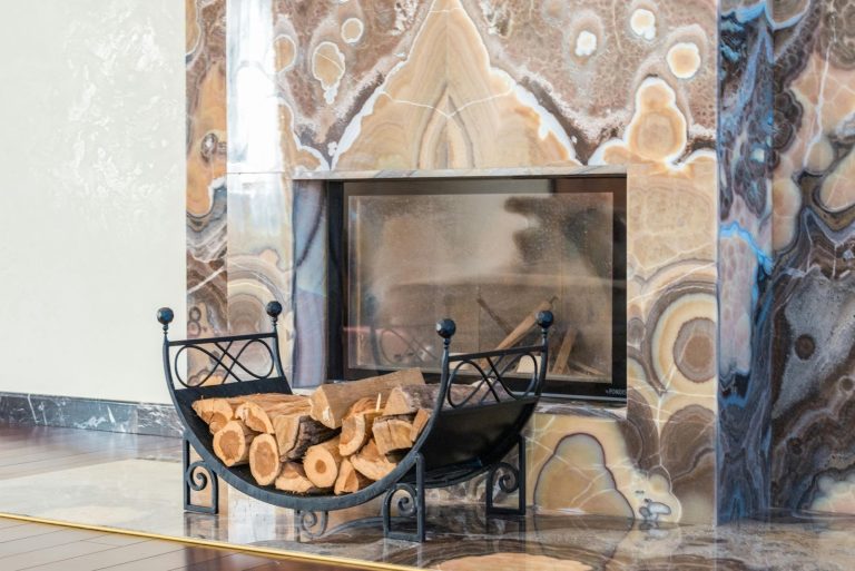 Modern statement fireplace with stacked firewood in a living room