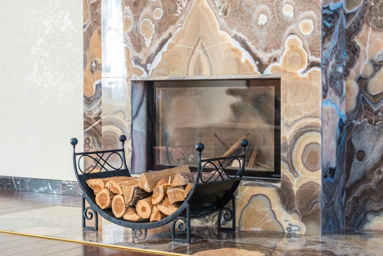 Modern statement fireplace with stacked firewood in a living room