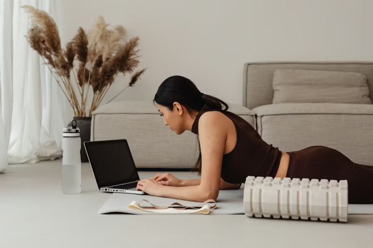 Woman working on a laptop at home while prioritizing personal well-being