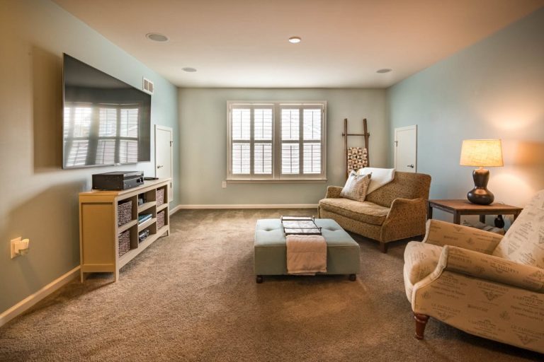 A well-measured living room with furniture arranged around a focal point before a full redecoration.