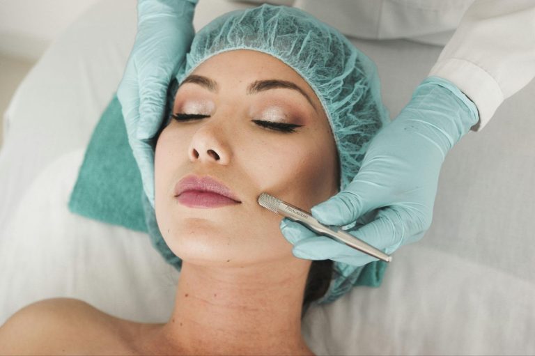 Esthetician performing a gentle facial treatment on a client with sensitive skin