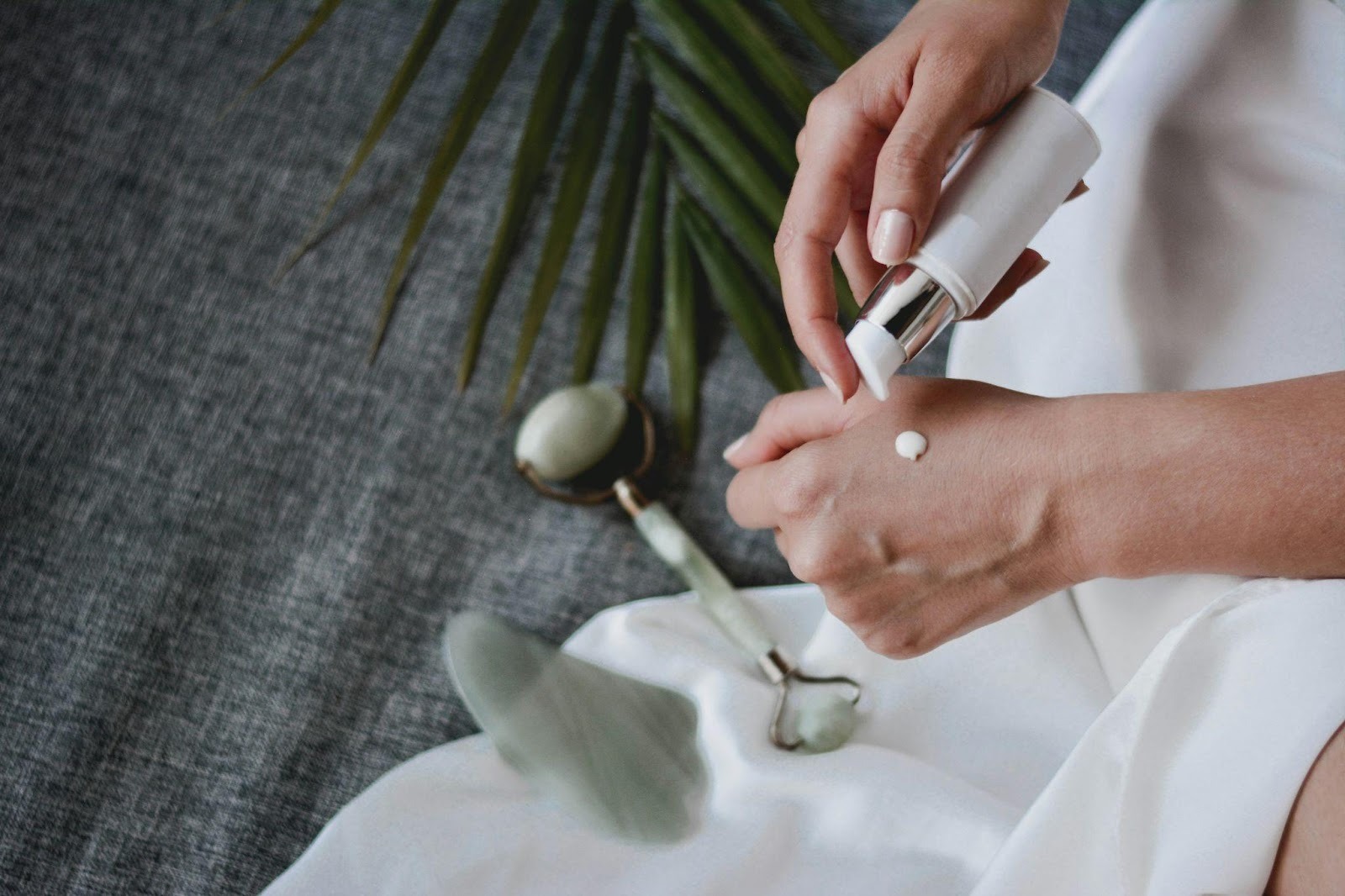 Person dispensing moisturizer onto their hand during a simple skincare routine