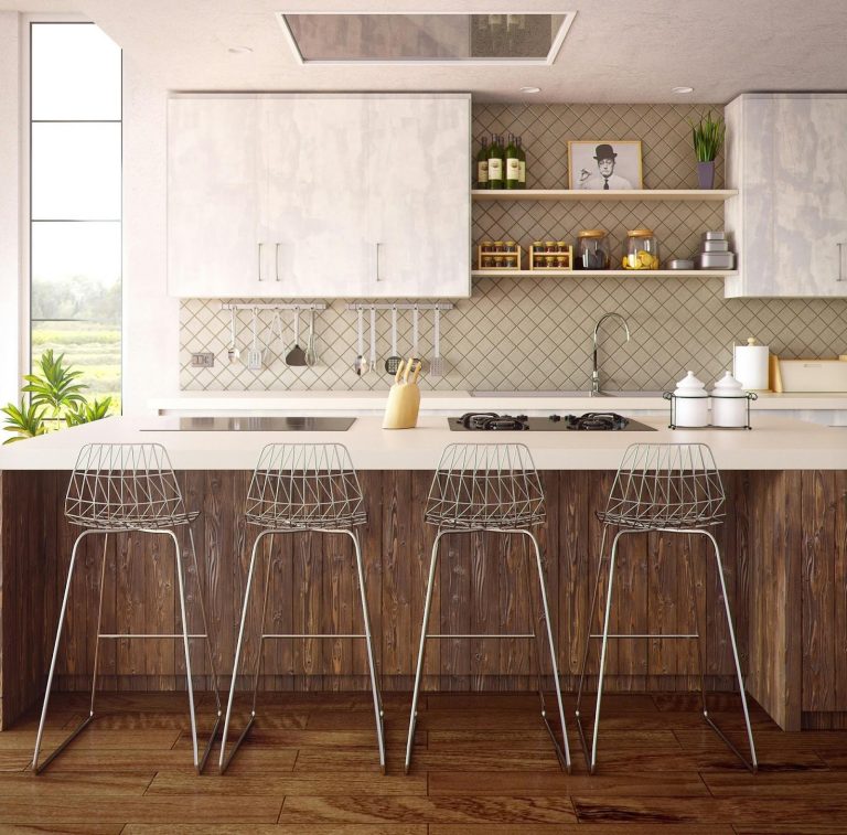 Modern open-plan kitchen with large island, bar stools, wood cabinetry, and layered lighting
