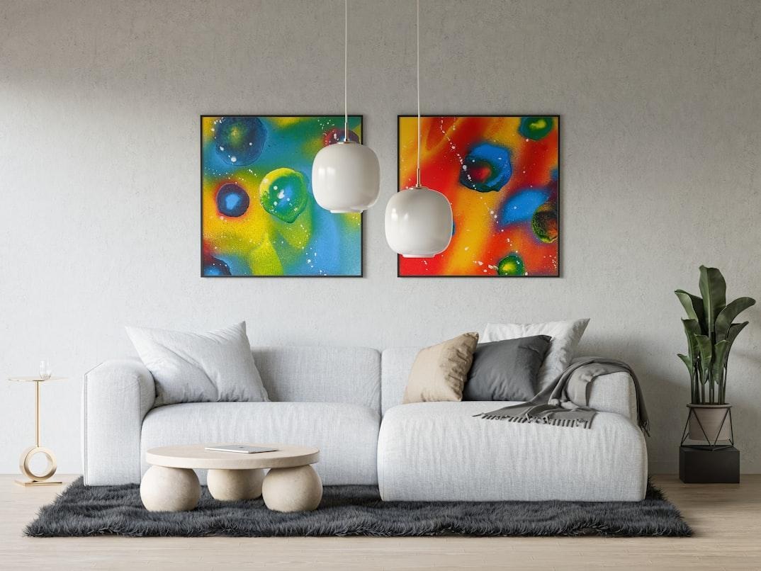 Modern living room with white sofa and colorful abstract wall art displayed above