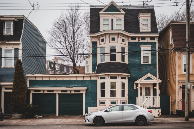 Traditional multi-story home with detailed trim, bold color, and strong architectural proportions