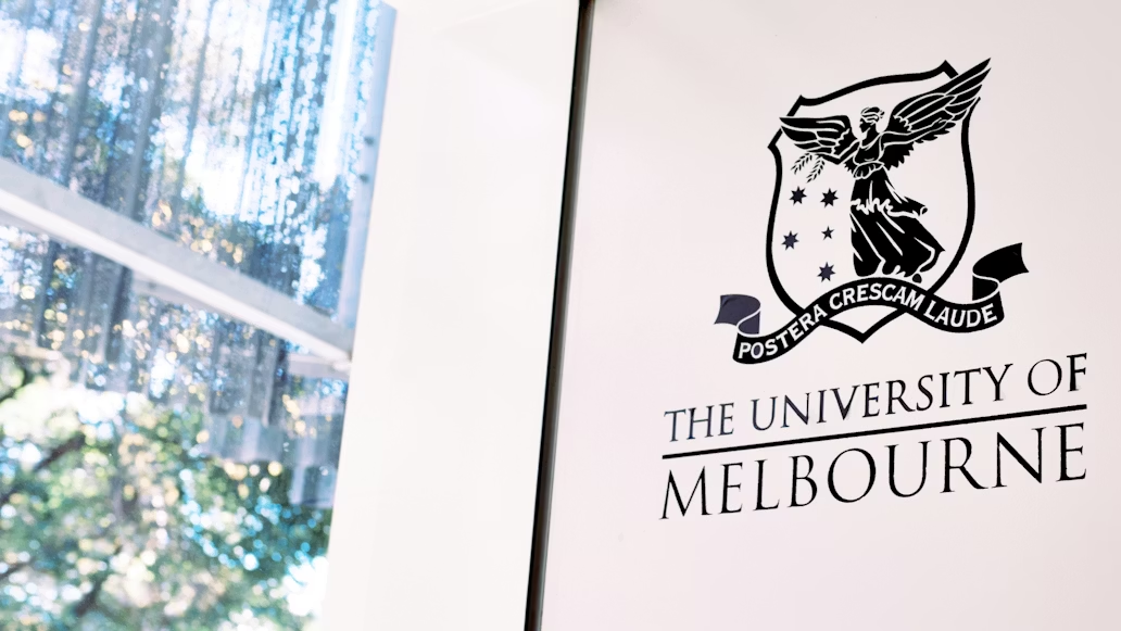 University of Melbourne logo displayed on a campus wall