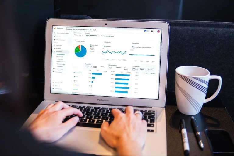Business owner reviewing analytics dashboard on laptop to build a sustainable business