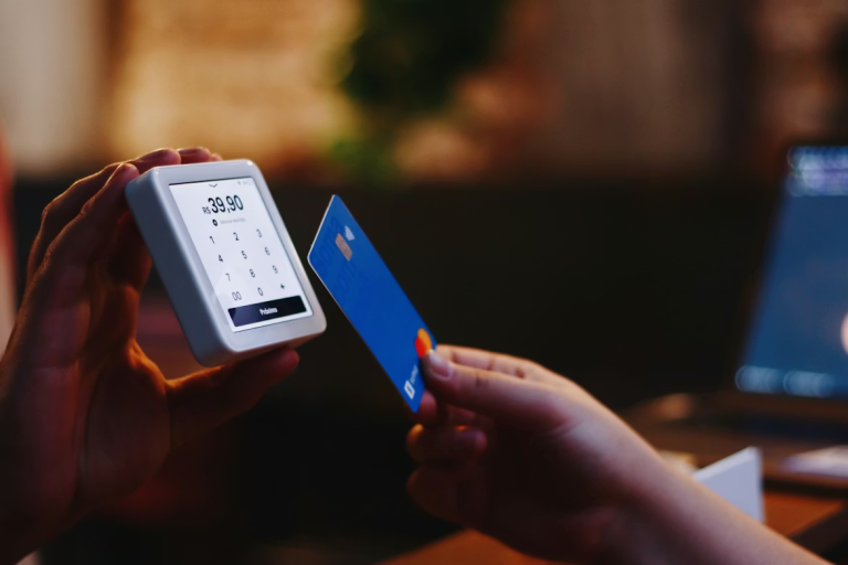Customer making a contactless card payment using a handheld payment terminal