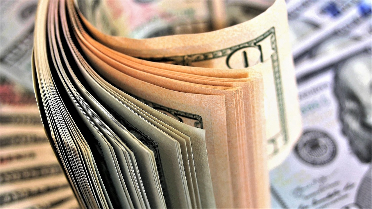 Stack of U.S. dollar bills representing improved cash flow and financial efficiency