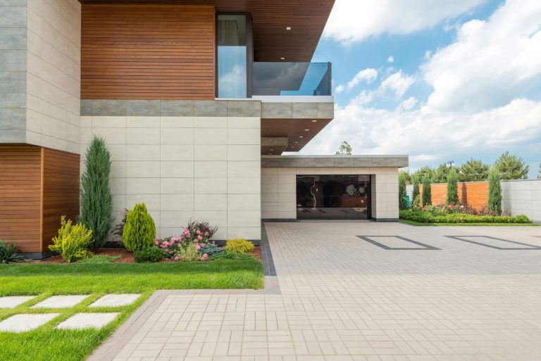Modern home exterior with secure driveway, garage, and gated entry system