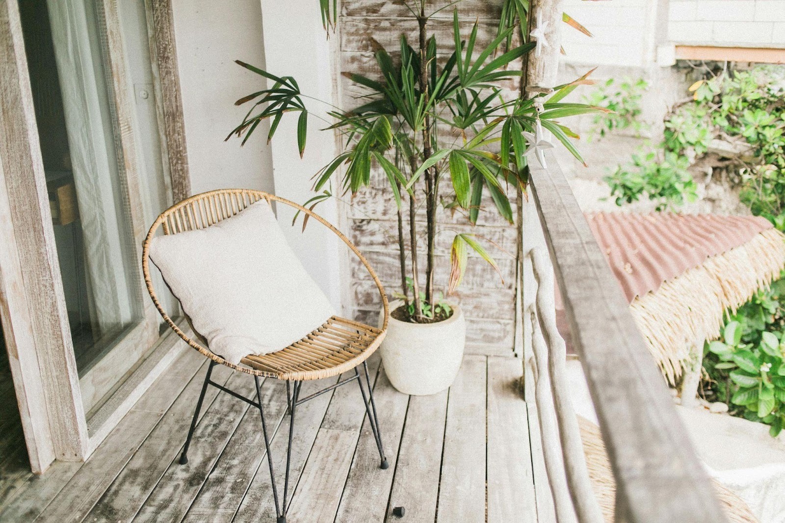 Stylish balcony with wicker chair and potted plant decor