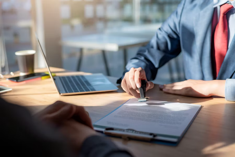 Professional stamping signed contract during business deal