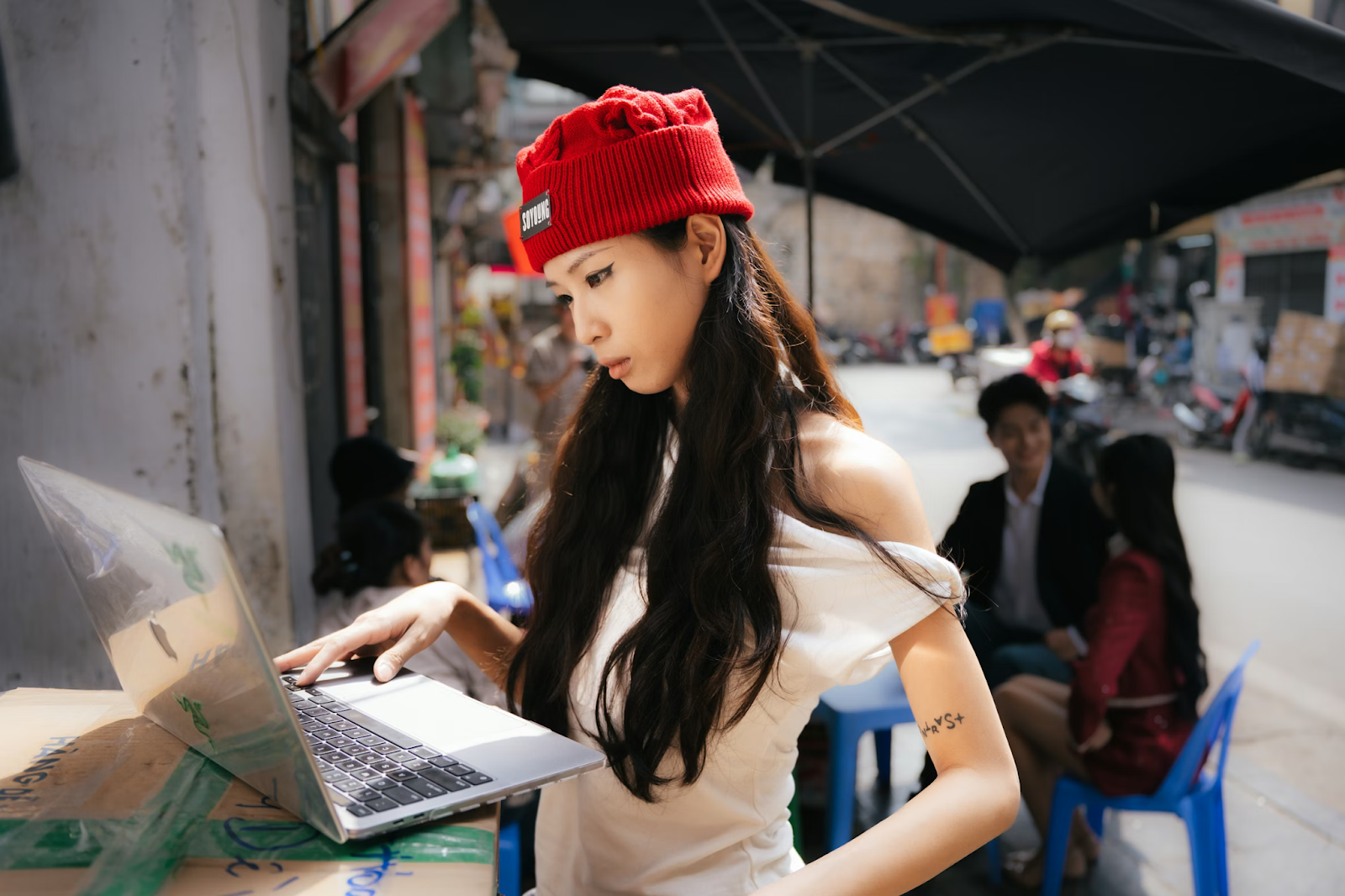 Content creator working on a laptop in an outdoor setting