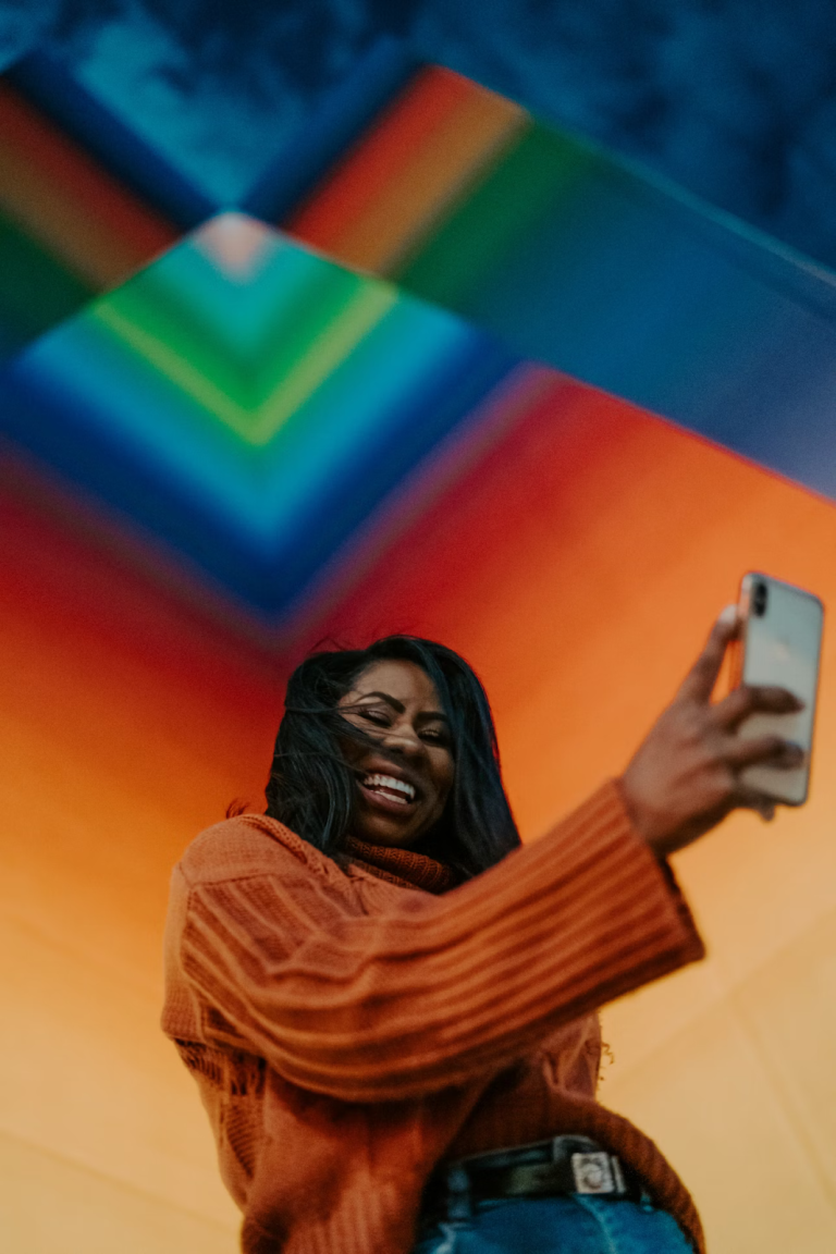 Content creator smiling while recording content on her phone