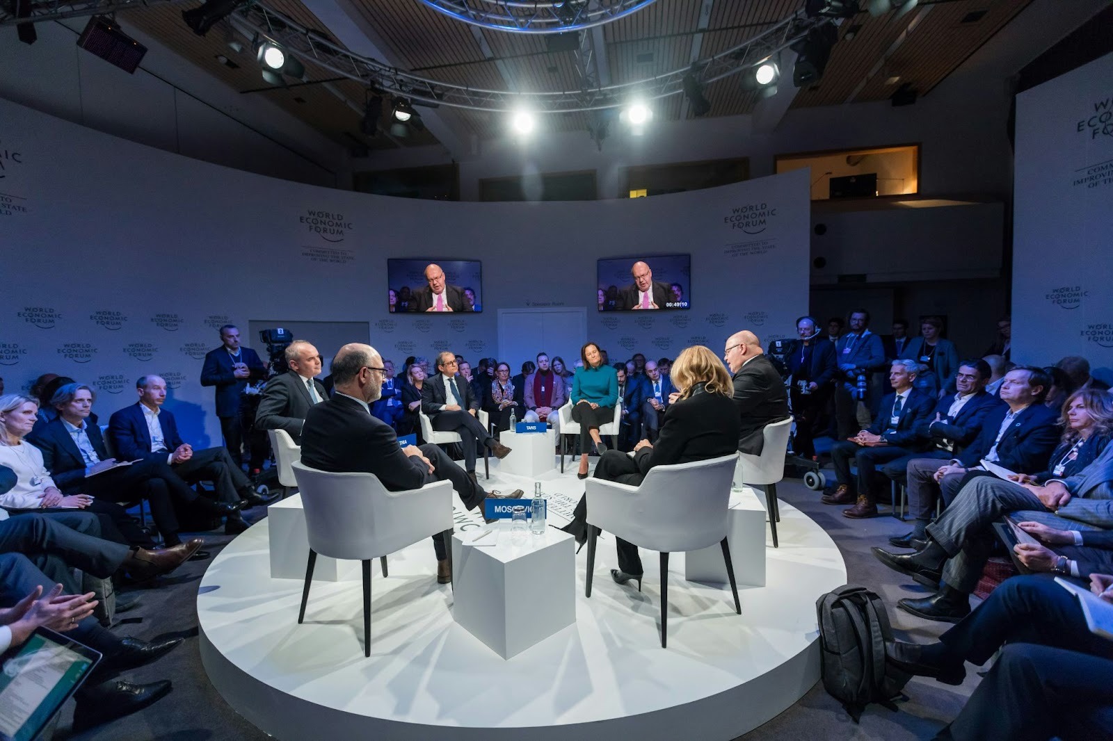 Business leaders participating in a panel discussion during a corporate conference event.