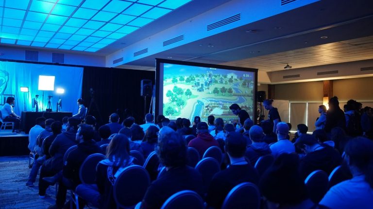 Audience watching a presentation during a corporate conference or business event.