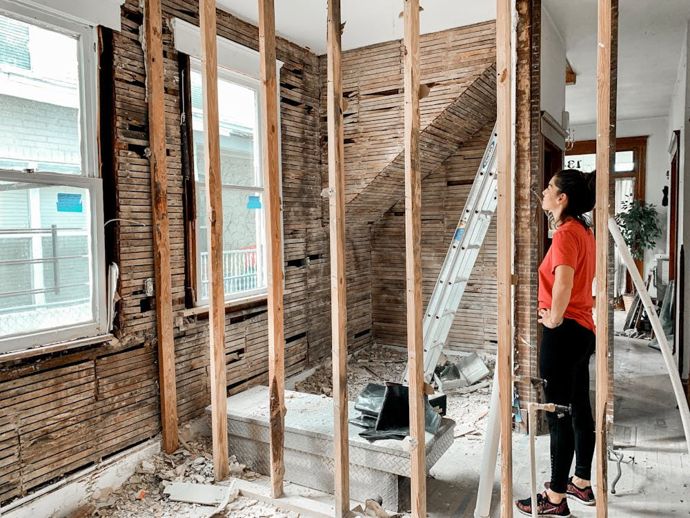 Home interior renovation with exposed wooden studs and demolition work before structural updates