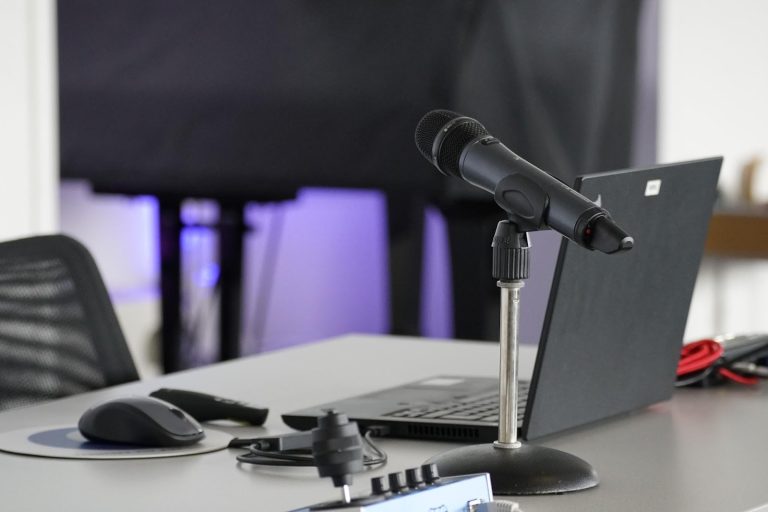 Microphone and laptop setup used for online meetings and digital communication