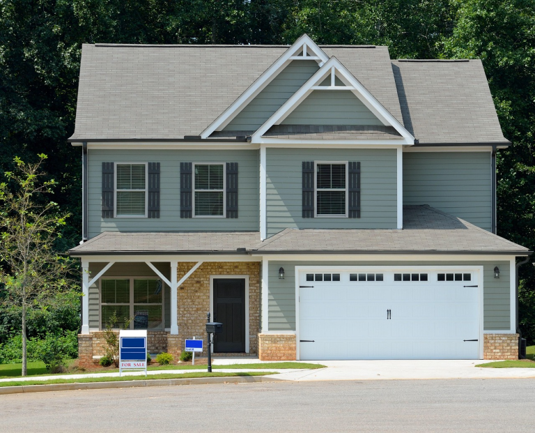 Single family home with for sale sign representing real estate investment opportunity