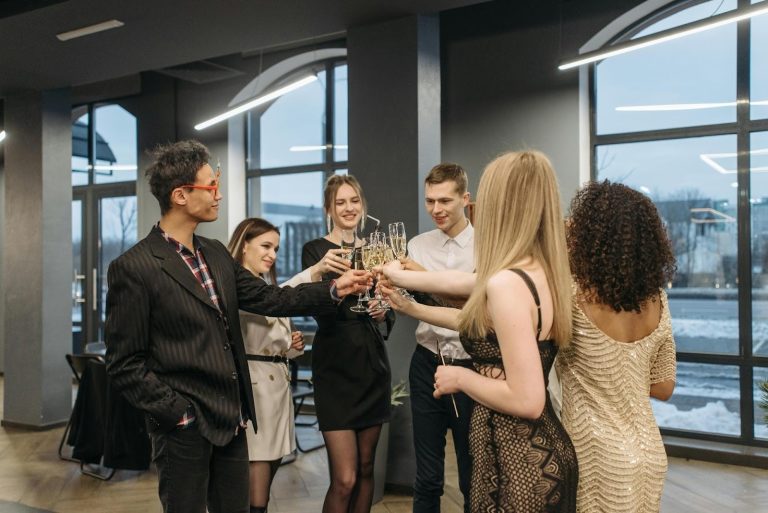 Group of professionals toasting drinks at an indoor business networking event