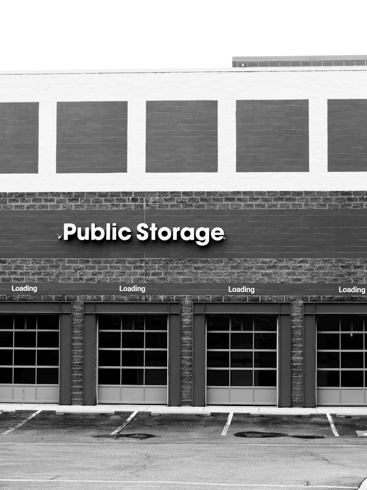 Exterior of a public storage building with multiple garage doors