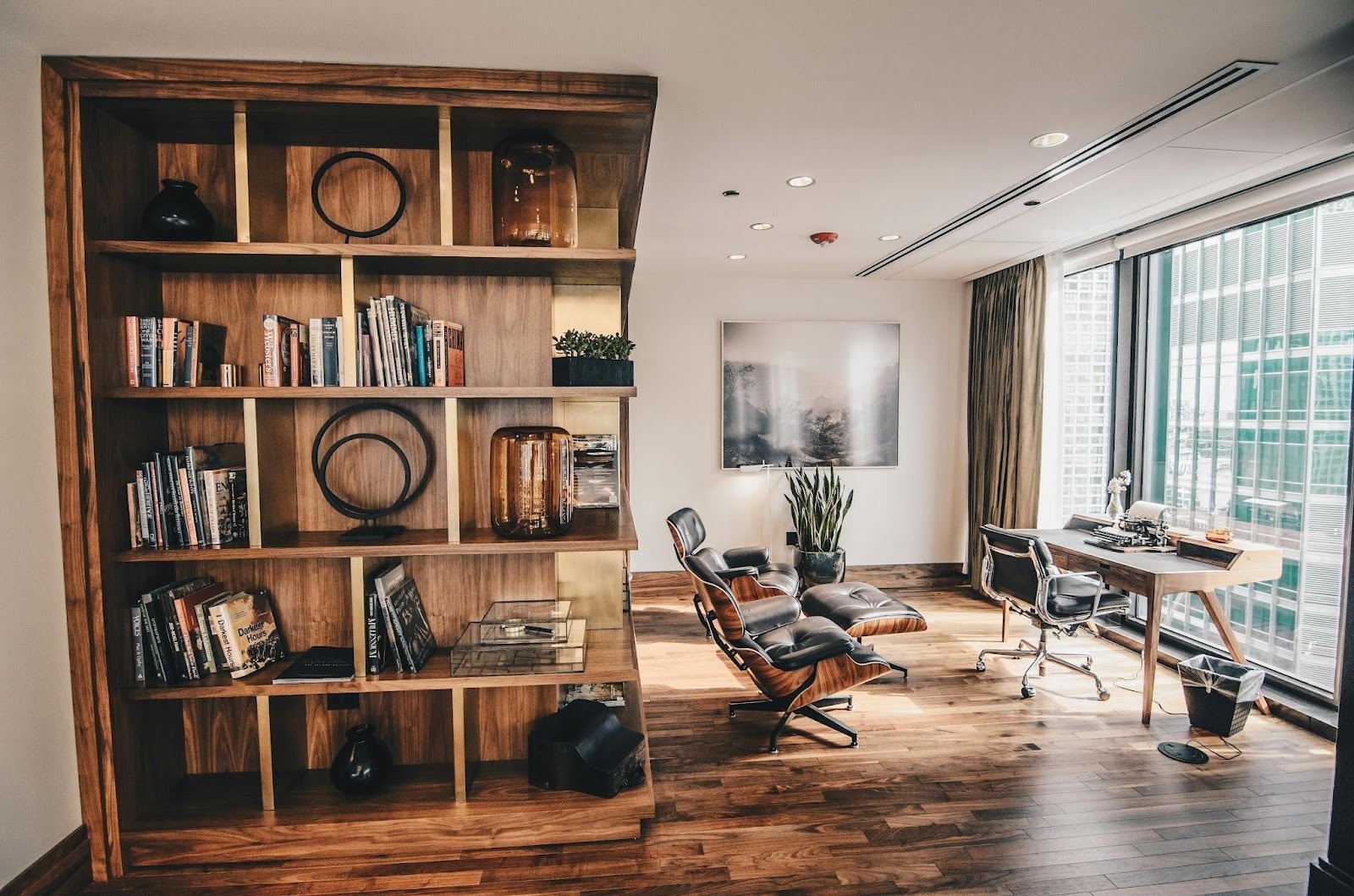 modern office workspace with desk, ergonomic chair, and bookshelf
