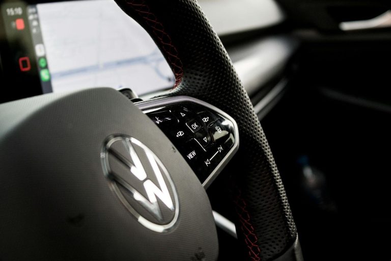 modern car steering wheel with controls showing vehicle longevity tips