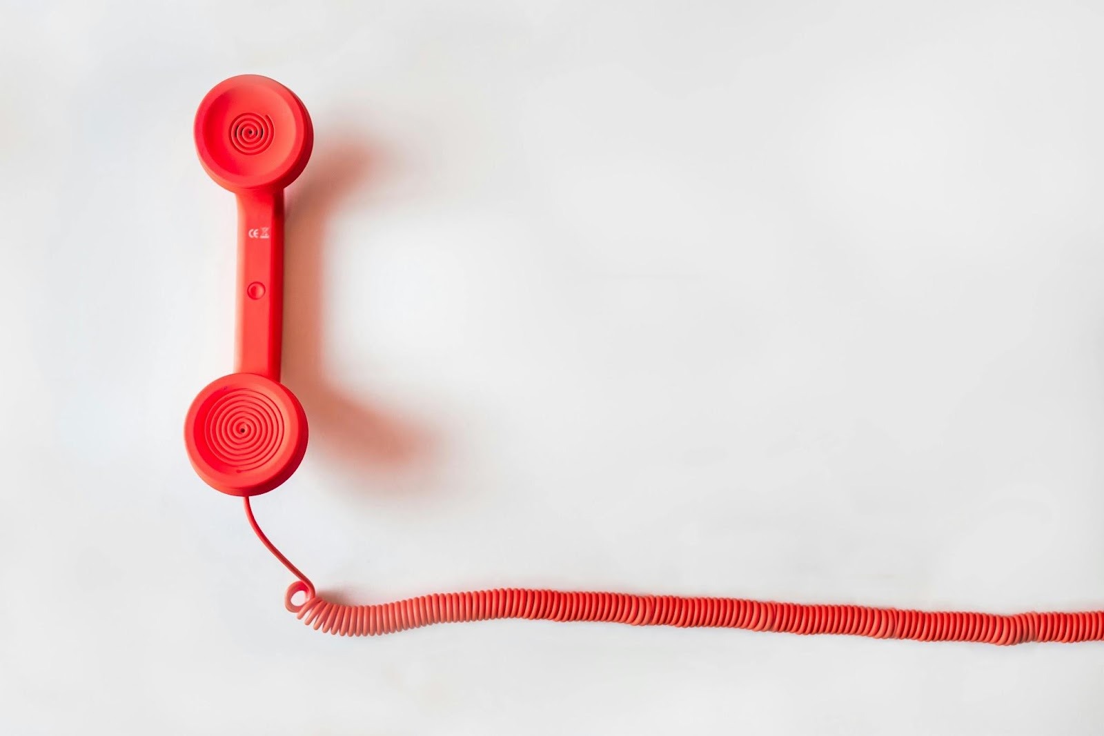 red telephone handset symbolizing unwanted scam calls