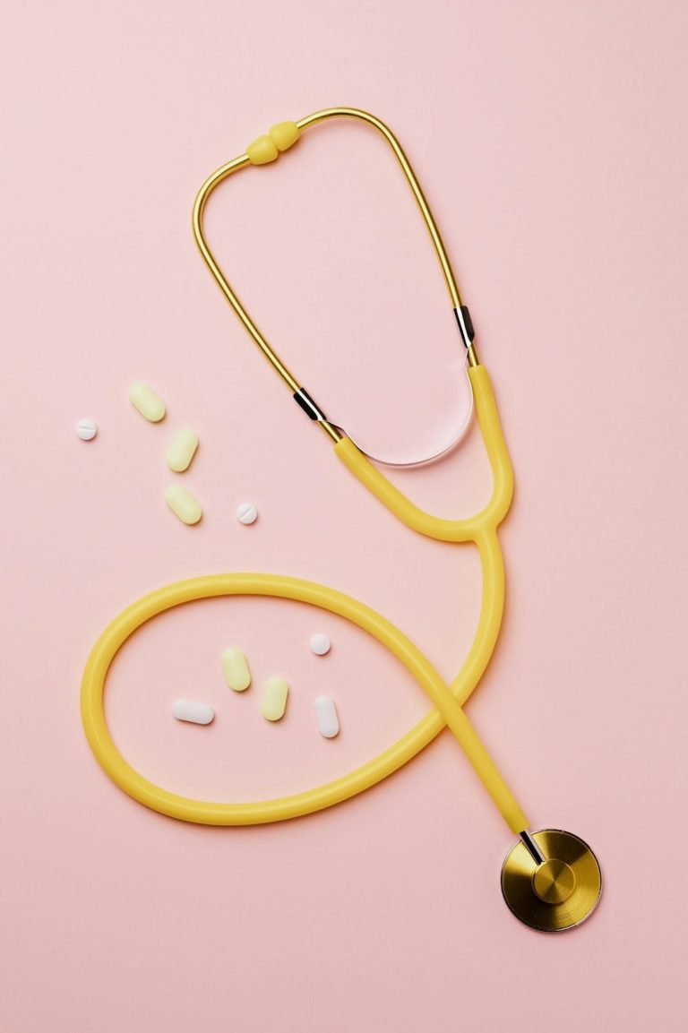 stethoscope and medication on pink background representing health challenges