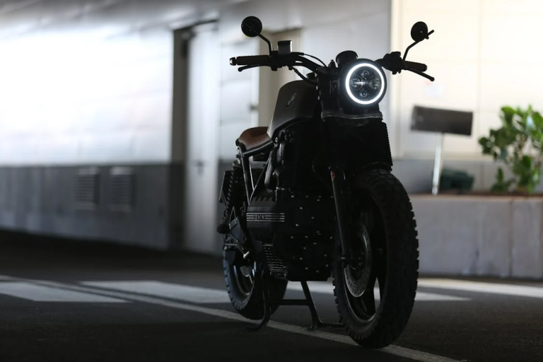 Black motorcycle parked indoors in a covered garage space