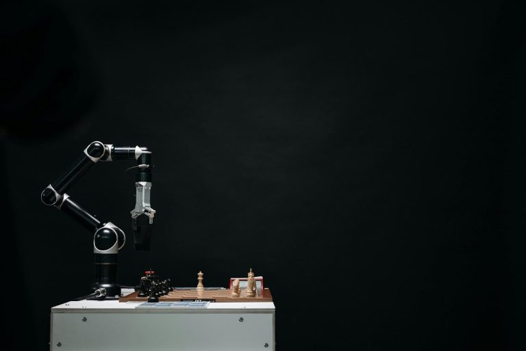 Robotic arm moving chess pieces on a chessboard against a dark background