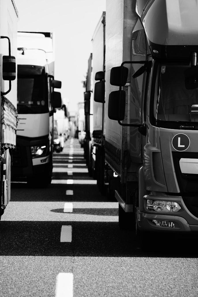 Commercial trucks driving in a fleet formation on a highway