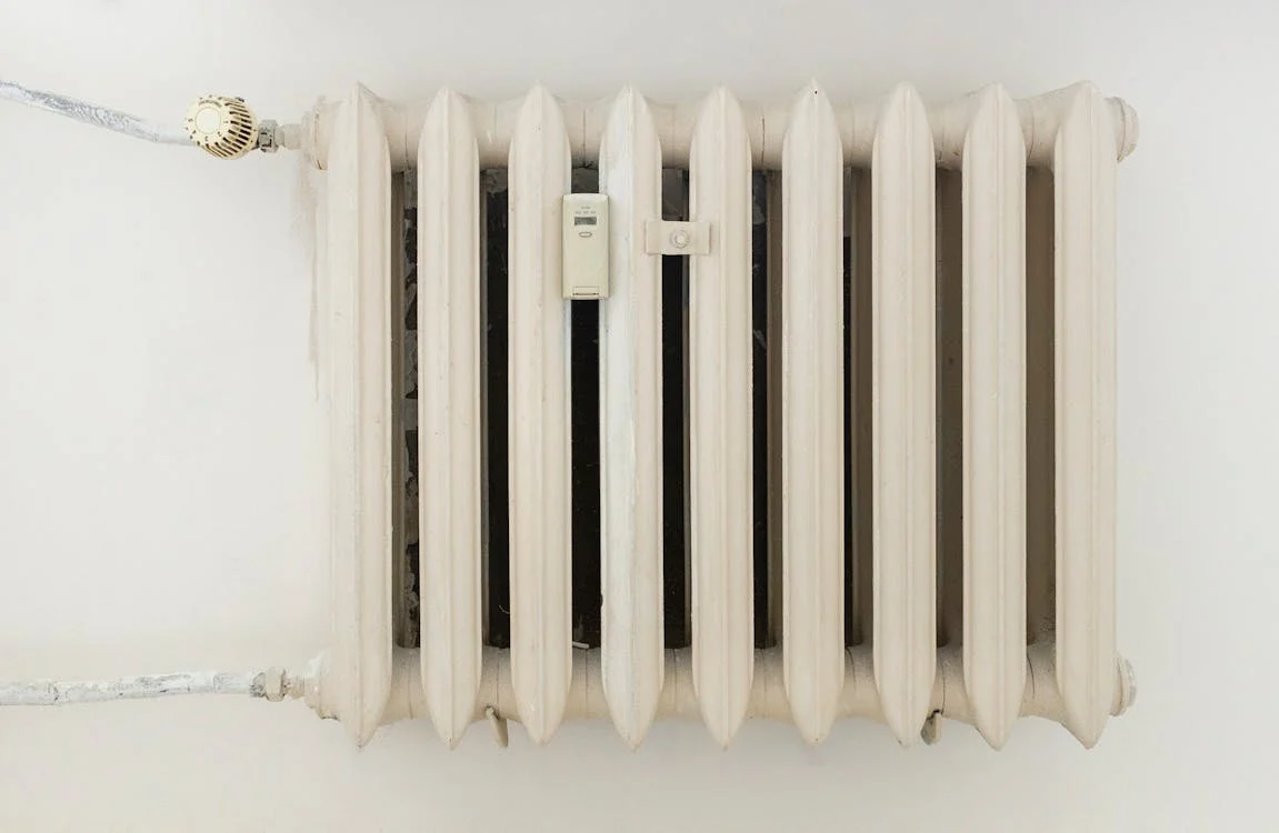 White wall radiator heater mounted indoors against a plain wall