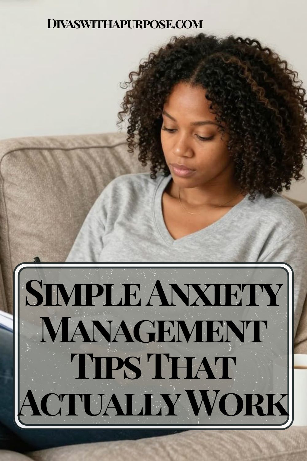 African American woman sitting on a couch journaling in a notebook with a calm expression, representing simple anxiety management tips that actually work