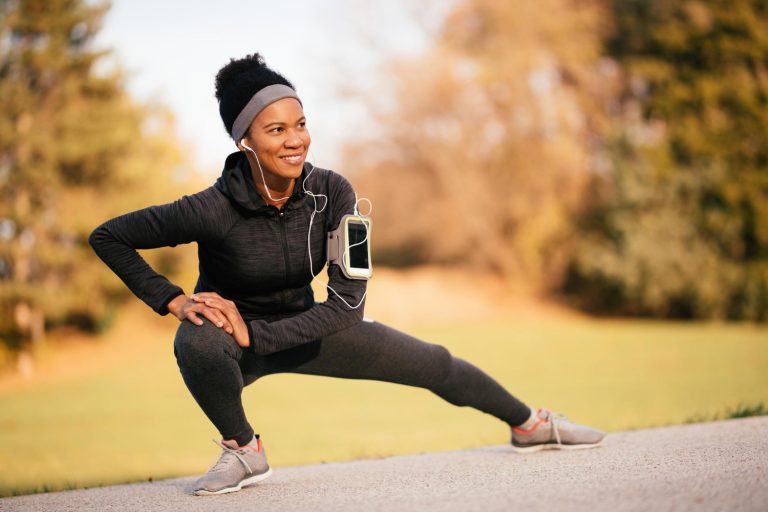 woman stretching outdoors during a fitness routine in a park