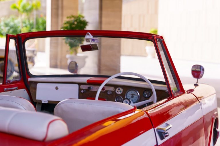 interior of a red convertible car showing dashboard and seats before purchase