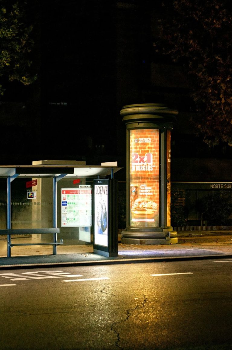 billboard and bus stop advertising display targeting local commuters at night