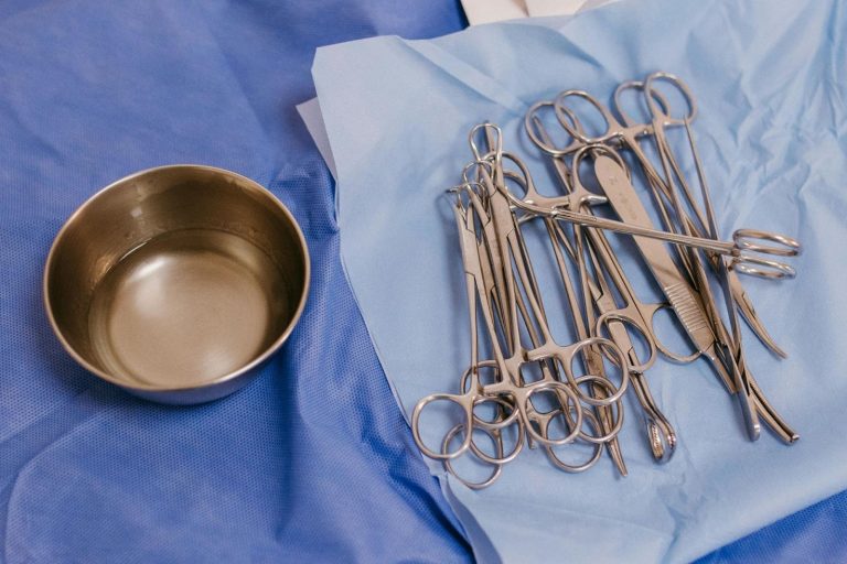 Sterile surgical tools and instruments arranged on a blue drape before an operation