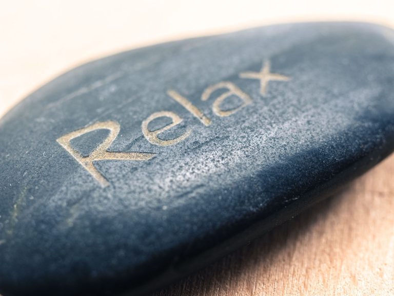 close up of stone engraved with the word relax representing ways to relax and reduce stress