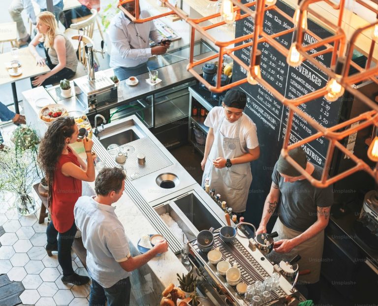 hospitality staff interacting with customer at coffee shop counter