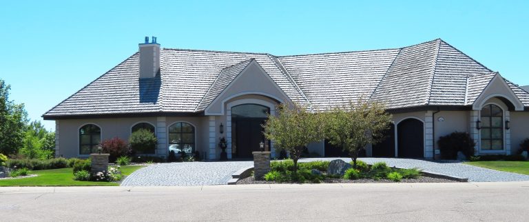 Large residential property with landscaped yard and driveway representing property ownership and home management