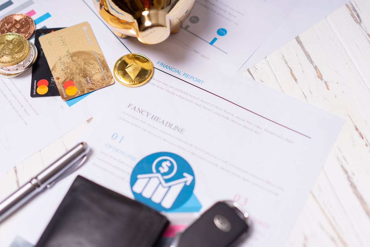 Financial reports, credit cards, cryptocurrency coins, and personal finance items displayed on a desk