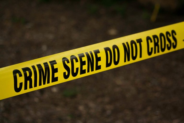 Yellow crime scene tape with the words “Crime Scene Do Not Cross.”