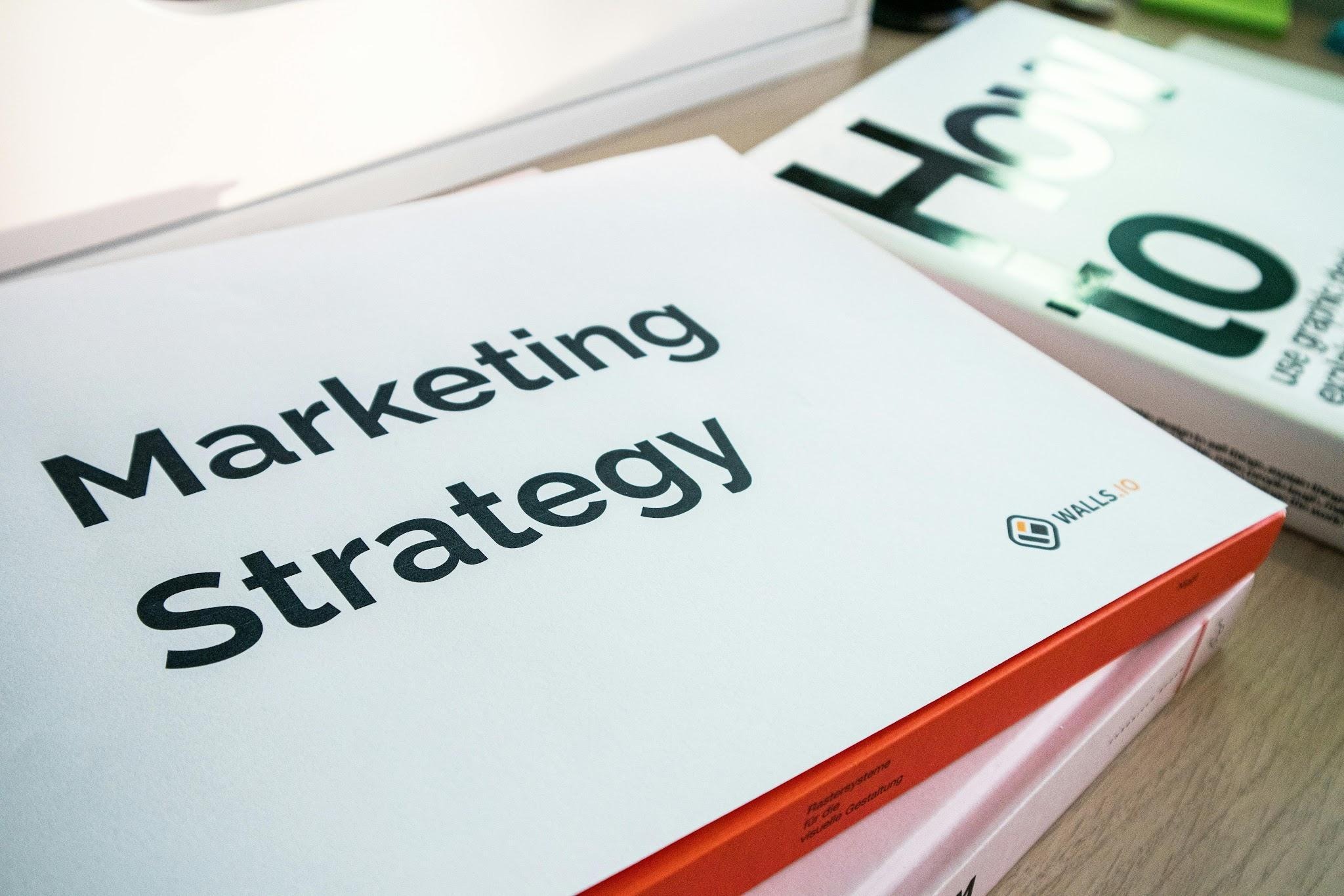 Marketing strategy materials and branding resources on a desk for solo entrepreneurs