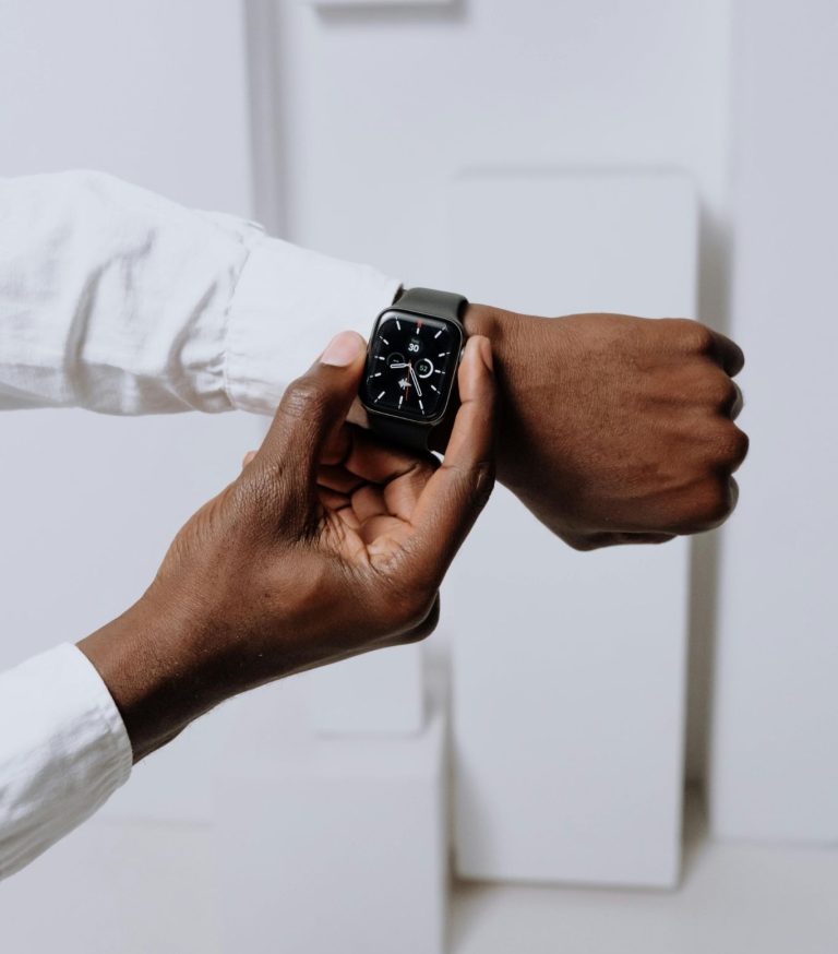 Person checking a smartwatch to monitor health and wellness tracking data