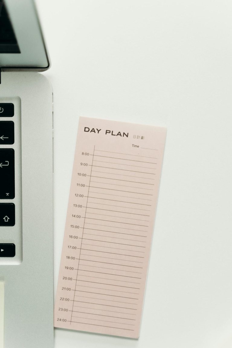 Daily planner beside a laptop representing healthier routines, structure, and better time management.