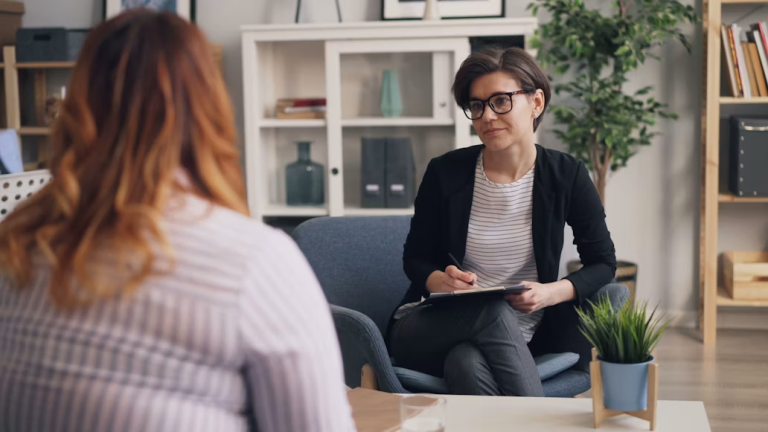 Woman speaking with a counselor during a supportive conversation about personal or family challenges.