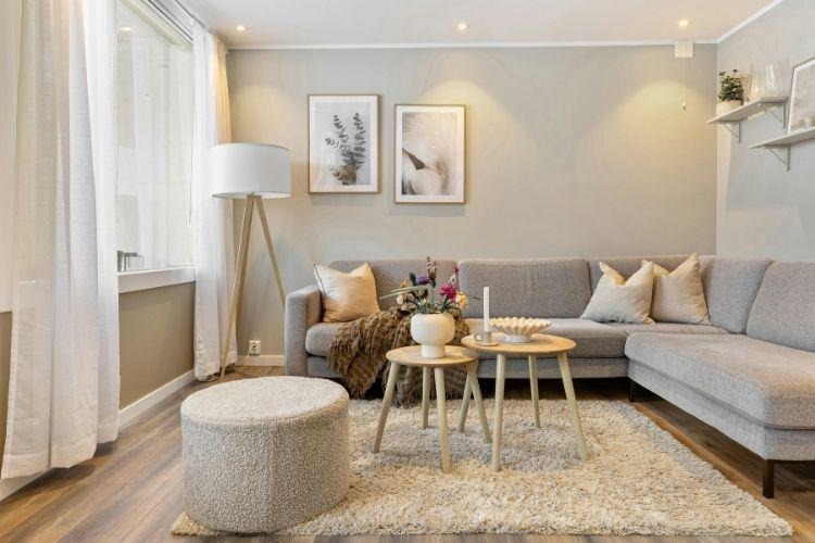 Modern small living room with neutral furniture, soft lighting, and cozy decor designed for comfort and relaxation.